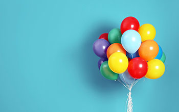 Bunch of bright balloons against a blue background